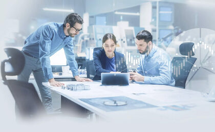image: Meeting in a conference room, all three people looking at an ipad.